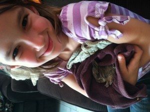 This is my girl holding a baby bunny she rescued from our cats and released back into the wild. She's drafting a book about it! 