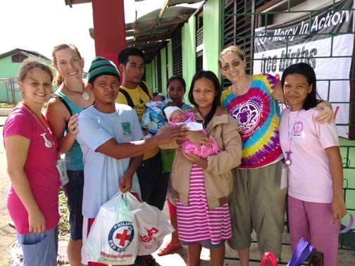 Family getting ready to go home... notice the improvised sign in the background. Mercy's founder, Vicki Penwell in rainbow shirt.