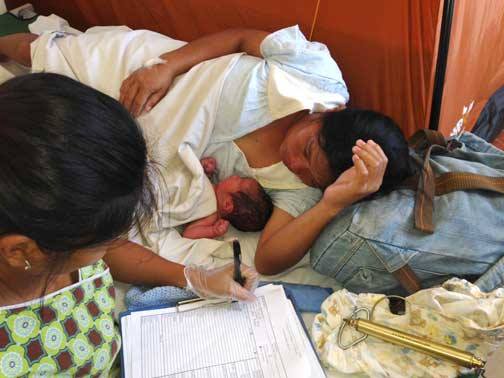 Newborn Check... one of 7 in one night. I wish I could reach through the picture and lay my hand on her head. 