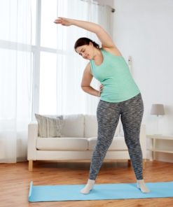 Home - Fit2B.com - smiling plus size woman stretching on mat at home