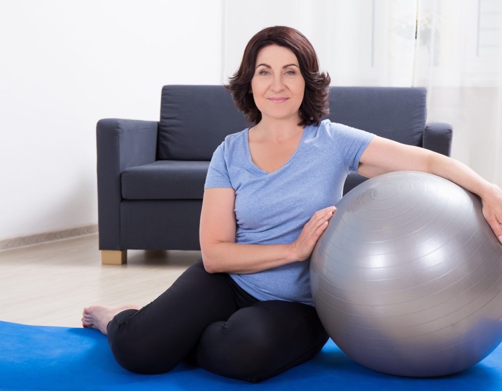 Woman holding balance ball - Fit2B.com