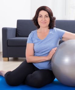 Woman holding balance ball - Fit2B.com