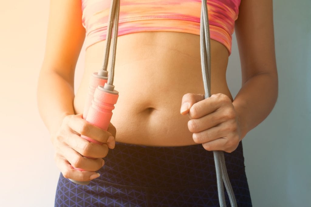 Sporty woman with jumping rope, Healthy and dieting concept - Fit2B.com - Fit2B Studio offers tummysafe workouts for dealing with diastasis recti in your home fitness practice.